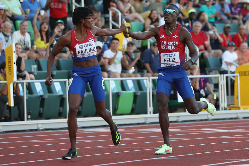 Track and field athletes racing on track